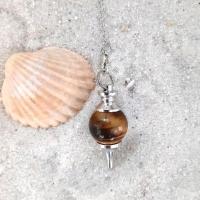 Pendule sphere oeildetigre missterreetciel